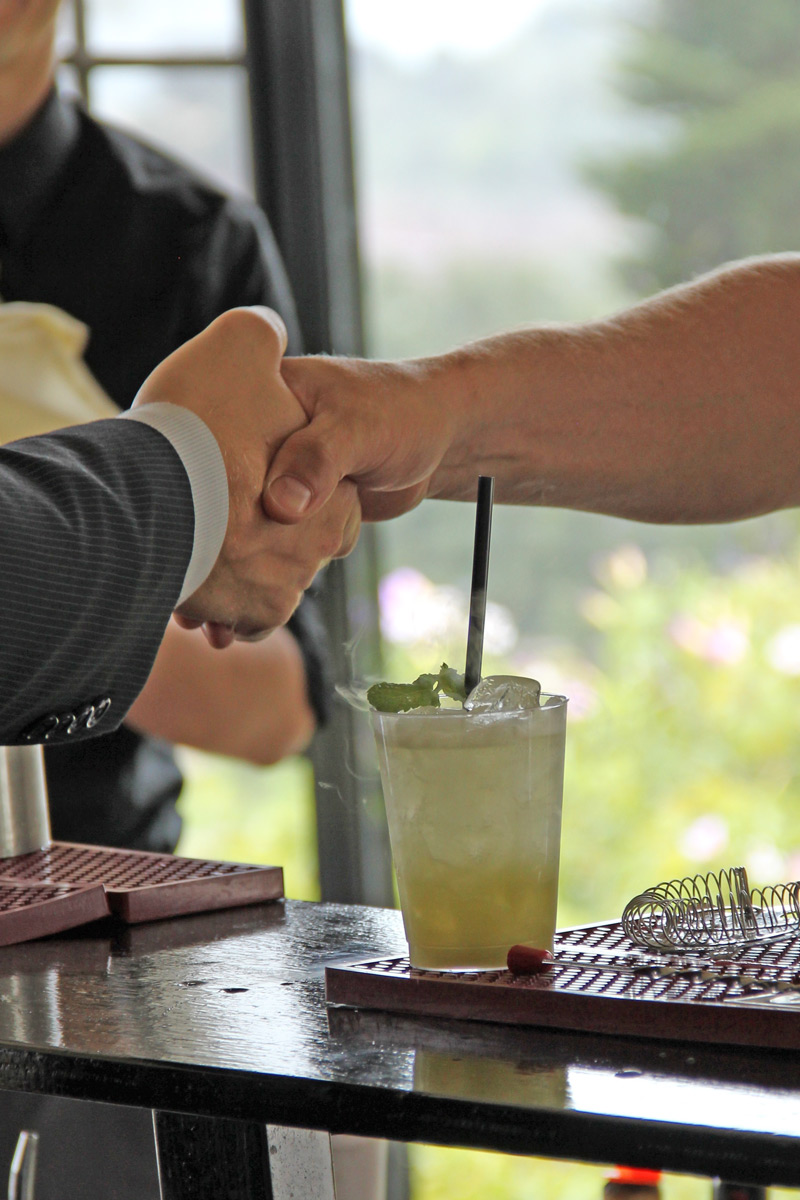 Shaking Hand Over Cocktail